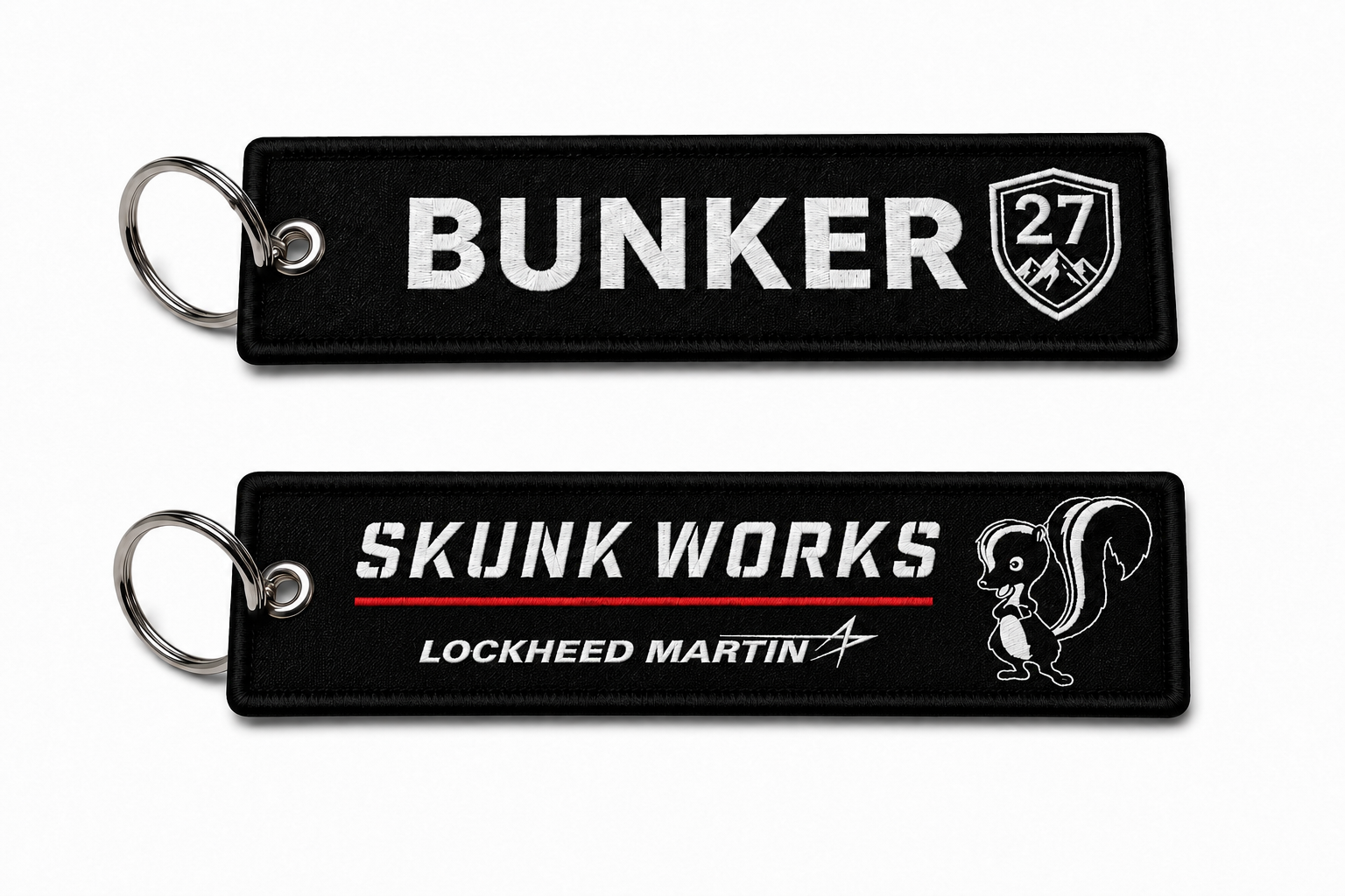 Two black keychains with 'Bunker' and 'Skunk Works' branding on a white background